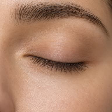 AI-generated illustration of subtle pigment along natural upper lash roots